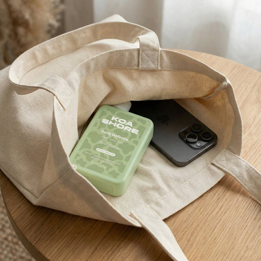 Koa Shore Daily Defence bottle in bag — skincare for outdoor men
