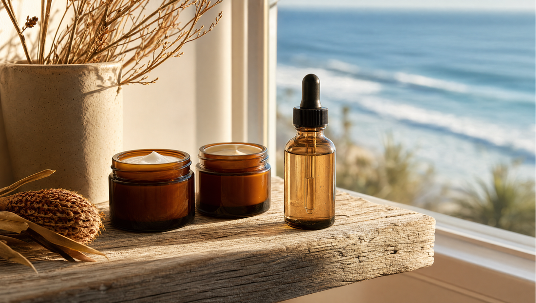 Minimal natural morning skin routine with amber glass jars arranged on a weathered coastal timber shelf in warm morning light