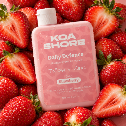KOA SHORE Daily Defence Strawberry bottle surrounded by ripe fresh strawberries.